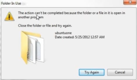 Windows error message showing “Folder In Use,” where a folder can't be deleted because it's being used by another program.