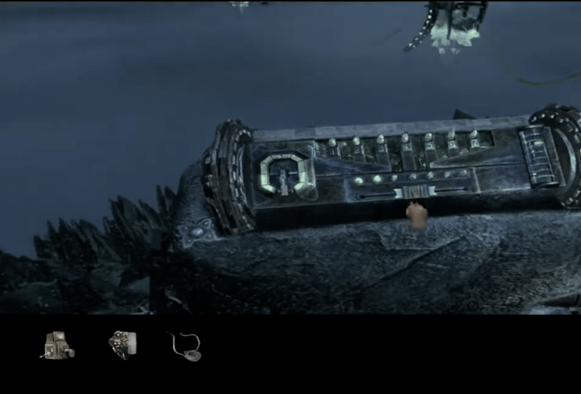 Screenshot from Myst IV: Revelation showing a dark, mechanical puzzle in an underwater-like environment.