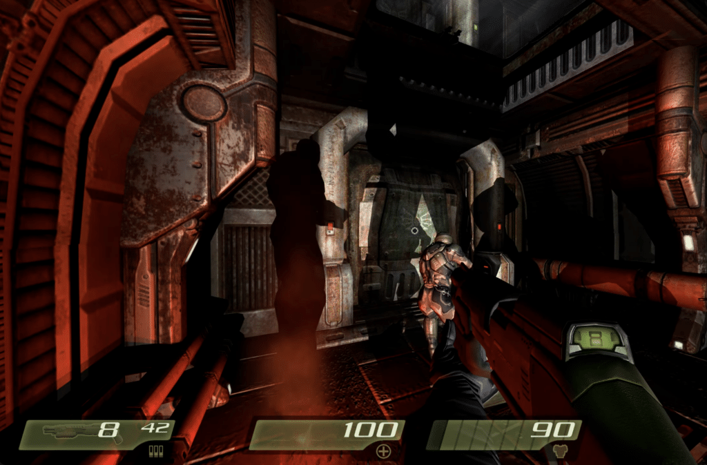Quake 4 gameplay with gunfight in a dark Strogg base, as a soldier moves through metallic sci-fi corridors.