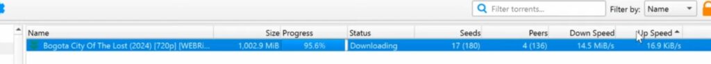 qBittorrent showing an active torrent download with status, seeders, peers, and download speed on Windows