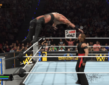 WWE 2K26 gameplay med wrestler, der springer fra hjørnet af ringen mod modstander foran et stort publikum.