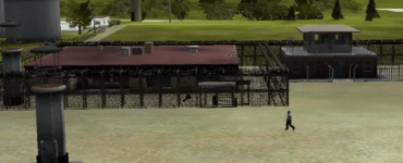 Skærmbillede fra Prison Tycoon 2 Maximum Security med fængselsbygninger, vagttårne, hegn og indsatte i et maksimumsikkerhedsfængsel