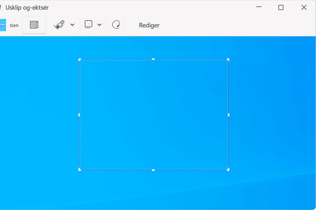 Screenshot Windows – værktøjet Udklip og skitsér åbent med markeret udsnit på blå Windows-baggrund.