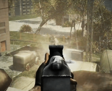 Gameplay fra Chernobyl Terrorist Attack, hvor spilleren sigter med et maskingevær mod fjender i et støvet område ved Tjernobyl.