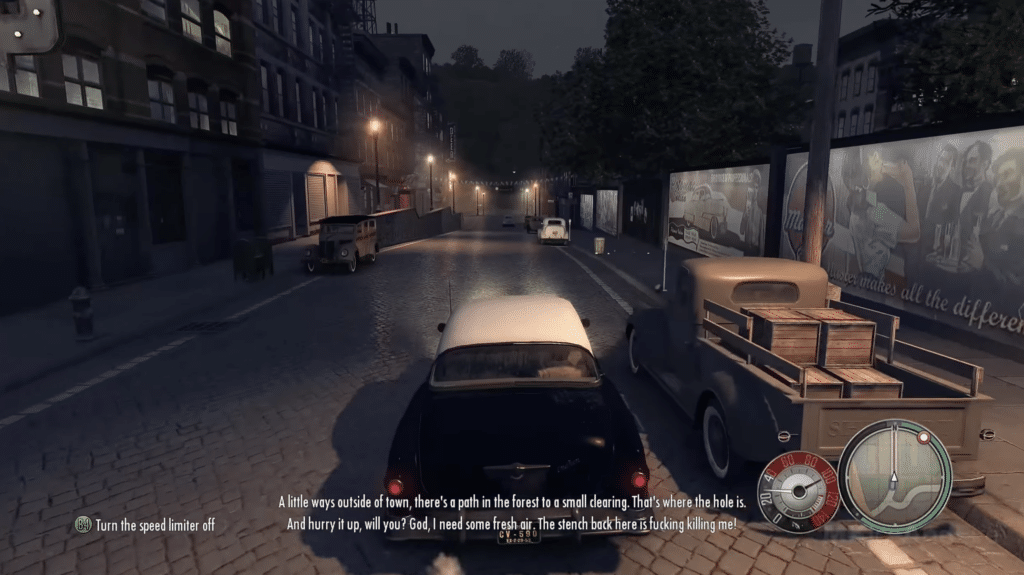 Screenshot fra Mafia 2, hvor Vito kører gennem Empire Bay om aftenen med bylys, klassiske biler og dialogtekst på skærmen.