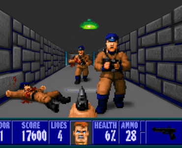 Skærmbillede fra Wolfenstein 3D, hvor hovedpersonen B.J. Blazkowicz er hårdt presset i kamp mod nazisoldater i en mørk stenbelagt korridor. Sundheden er lav, og fjender nærmer sig fra begge sider i klassisk pixelgrafik.