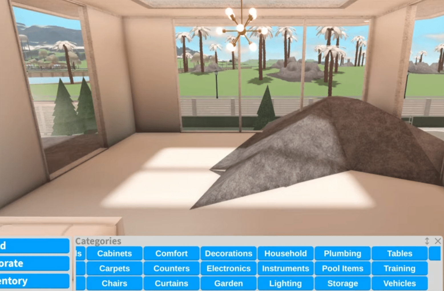A screenshot from the Roblox game Welcome to Bloxburg, showing the build menu at the bottom with categories like Cabinets, Comfort, Decorations, and Lighting. In the background is a bright, modern room with large glass panels, a minimalist chandelier, and a view of palm trees and green landscape.