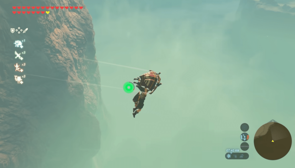 Link svæver med paraglideren gennem tågen ved en høj klippe i The Legend of Zelda: Breath of the Wild.