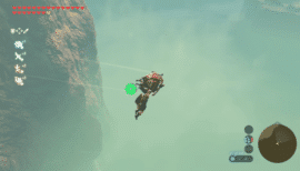 Link svæver med paraglideren gennem tågen ved en høj klippe i The Legend of Zelda: Breath of the Wild.