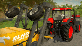 Rød Zetor-traktor med frontlæsser og gult landbrugsredskab i Farming Simulator.
