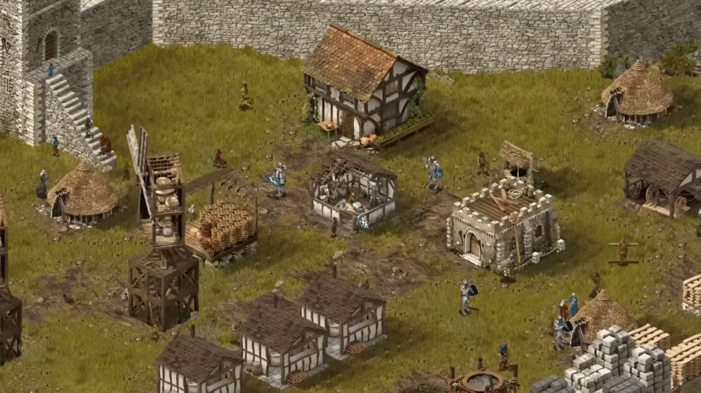Screenshot fra Stronghold: Definitive Edition, hvor borgens indre ses med boliger, lager, soldater, stenmure og middelalderlig produktion.